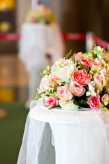 Artificial flowers bunch decorated on table.