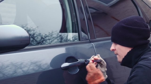 The thief hacks the door lock in the car