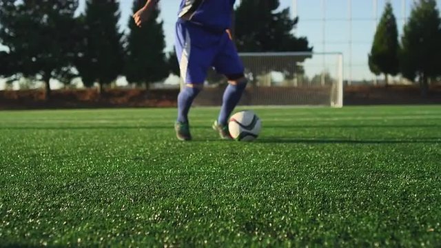 A soccer player does some fancy footwork while going up against other players
