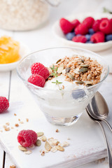 Healthy breakfast. Granola with pumpkin seeds, honey, yogurt, fresh berries .