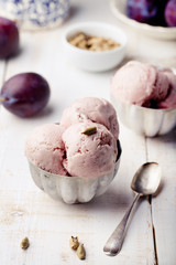 Plum ice cream with cardamon seeds. White background. 