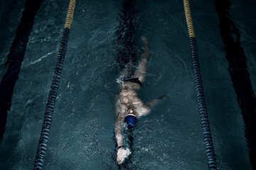 Sportsman swims in a swimming pool
