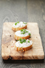 crunchy baguette slices with cream cheese and green onion
