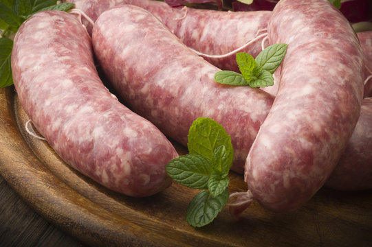 raw homemade sausage on a wooden board