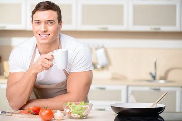 Young nice-looking man enjoy his coffee break. 
