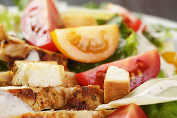 caesar salad with chiken fillet and different color tomatoes