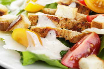 caesar salad with chiken fillet and different color tomatoes