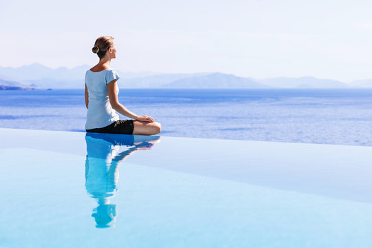 Young woman relaxing outdoors. Young beautiful girl doing exercises at home. Harmony, balance, meditation, relaxation, healthy lifestyle, mindfulness concept