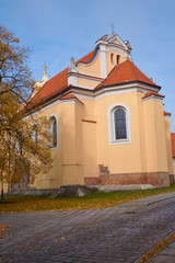 Fototapeta na wymiar Medieval Romanesque church in autumn in Gniezno.