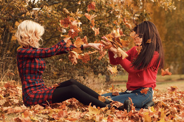 Two beautiful girls in autumn park