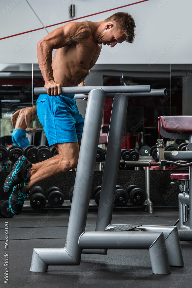 Wall mural Man during workout in the gym