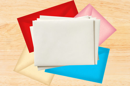 Color letters envelopes over wooden texture