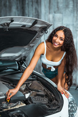 Fototapeta na wymiar Concept for young sexy female car repair
