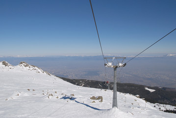 Chairlift on Vitosha mountain, at the bottom you can see Sofia City - the capital of Bulgaria