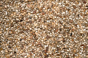 Cement wall surface covered with stones