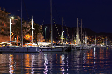 Modern yachts in quay at night