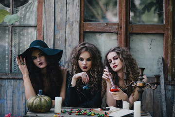 Three vintage witches perform magic ritual