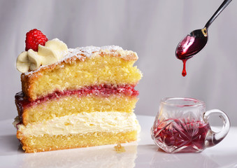 Home-made Victoria Sponge cake with raspberry jam and fresh cream
