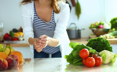 Young woman sitting near desk in the kitchen