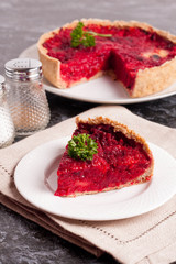 Beetroot pie with feta cheese on white plate