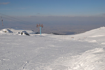 Chairlift on Vitosha mountain, at the bottom you can see Sofia City - the capital of Bulgaria