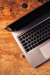 Laptop computer on rustic wooden office desk