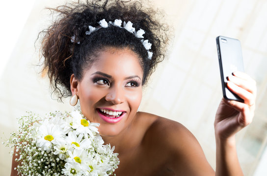 Portrait of beautiful exotic emotional bride taking a selfie
