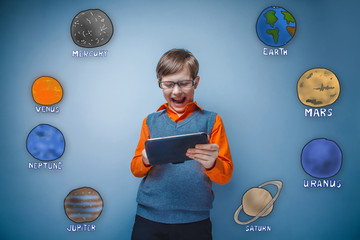 Teen boy with glasses grins and runs on a gray plate planets of 