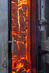 View of the finished coke into the open door of the coke oven