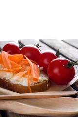 Bread with cheese and carrot on wooden board