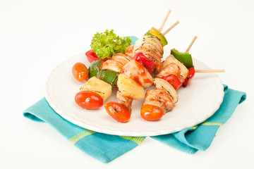 Fried barbeque meat on a bamboo sticks with vegetables