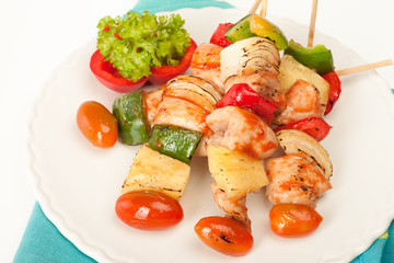Fried barbeque meat on a bamboo sticks with vegetables