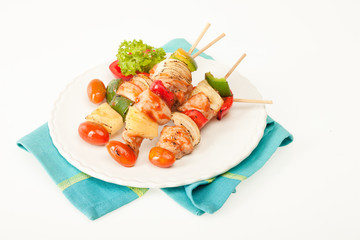 Fried barbeque meat on a bamboo sticks with vegetables