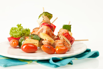 Fried barbeque meat on a bamboo sticks with vegetables