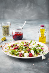 Salad with arugula, cherries and goat cheese.