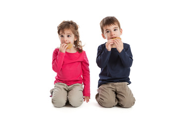Twins eating cookies