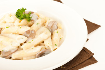 Pasta with mushrooms in white cream sauce