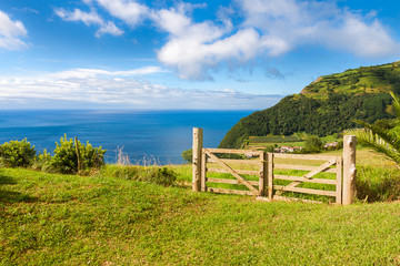 Fototapeta na wymiar Fields and fence over Atlantic Ocean in Sao Miguel, Azores Islan