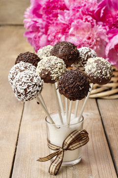 Chocolate cake pops on wooden table.