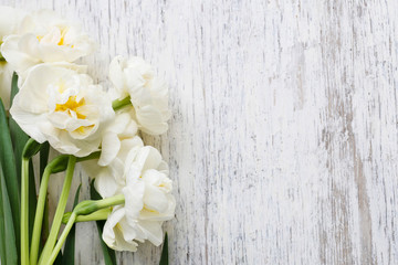 White narcissus flowers on wood