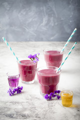 Blueberry, blackberry, honeysuckle, honeyberry smoothie with violet syrup and acai. 