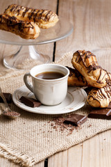 Cup of coffee and eclairs