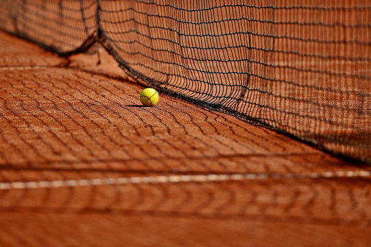 Tennis ball on tennis clay court