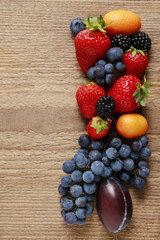 Strawberries, blueberries, blackberries, grapes and kumquats on