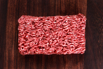 Fresh raw minced beef on wooden table