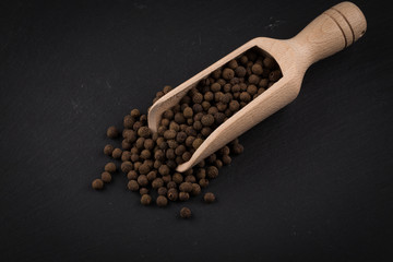 Wooden shovel with black peppercorn