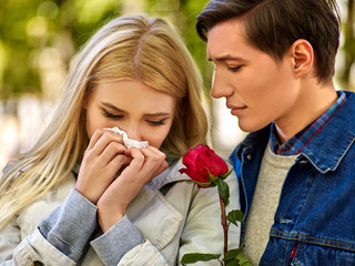 People with a cold blowing nose  handkerchief fall outdoor.