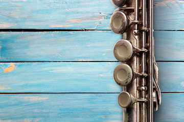 Old flute on blue wooden boards © Zerophoto