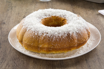 coconut cake with slice on the table