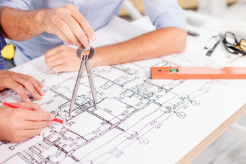 Experienced male architects are working at project